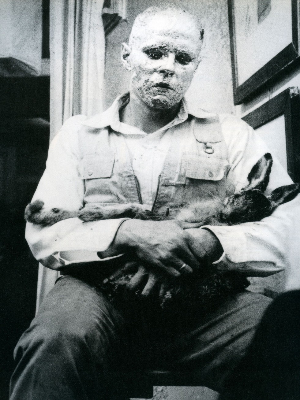 Artist Joseph Beuys during his performance with a dead hare at the Galerie Schmela in Düsseldorf. Wie man dem toten Hasen die Bilder erklärt [or How to Explain Pictures to a Dead Hare], 1965.