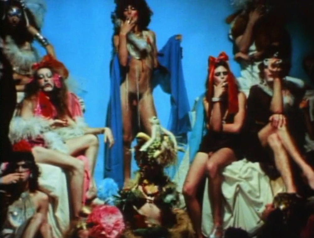 The Cockettes on set. Hibiscus is in the middle with exotic fruits. A still from Luminous Procuress (1971) A FILM BY STEVEN ARNOLD. Colour, Sound, 74mins, 16mm.