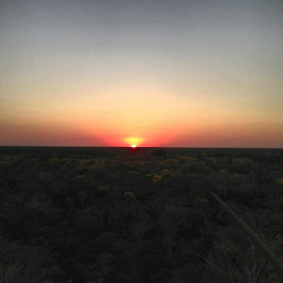 Enchanting sunset over the jungle as seen from the top of Ikil Pyramid.