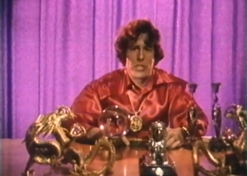 KENNETH ANGER at his altar during an interview in the documentary portrait 'Kenneth Anger - Magier des Untergrundfilms [Magician of Underground Film] by Reinhold E. Thiel, 1970. "And so he built a sort of altar, behind which he made his statements, robed as a magician and artist", says Thiel of this particular moment.