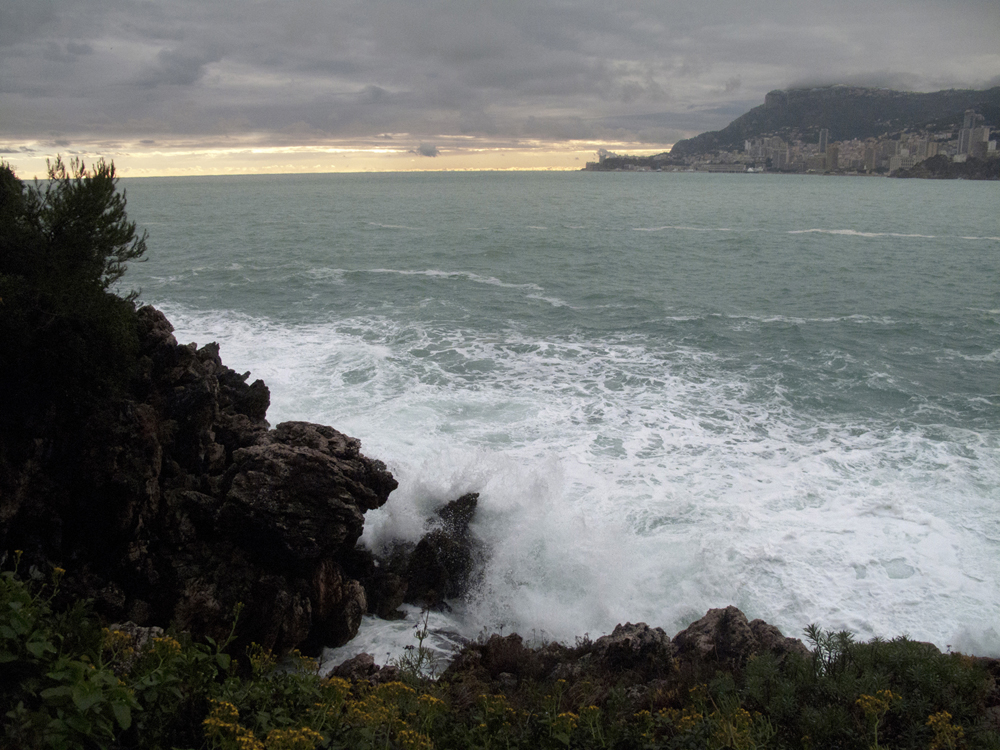 The force of the sea submerging the rocks.