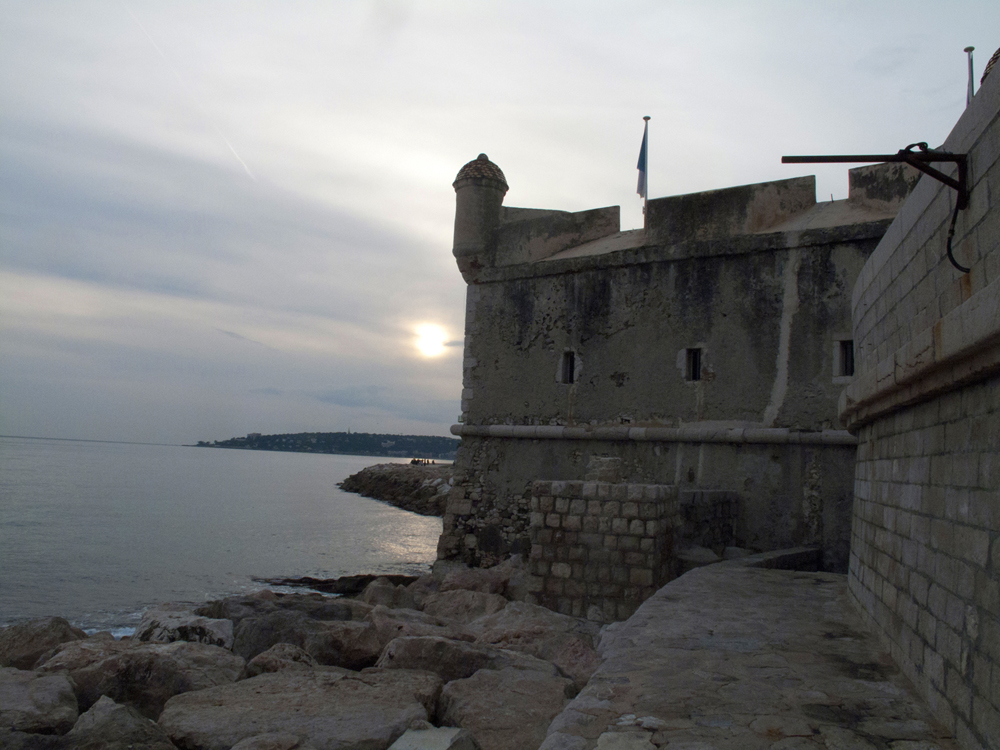 The sun peering through a veil of clouds outside the Bastion Museum in Menton.