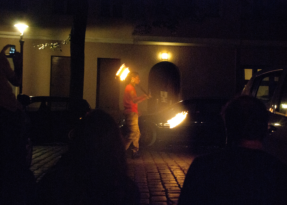 The Third Eye's Mexican friend Motor playing fire in the street in front of AKA Galerie.