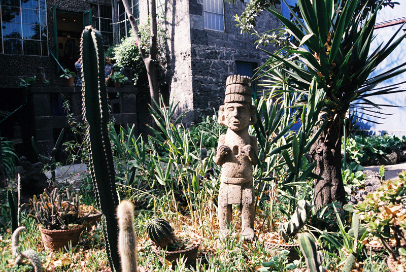A Pre-Hispanic statue in the Casa Azul's garden with a view into the house.