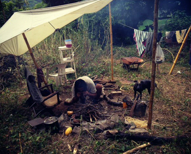 Imix Jaguar with his dog Teahui at the kitchen seed camp.