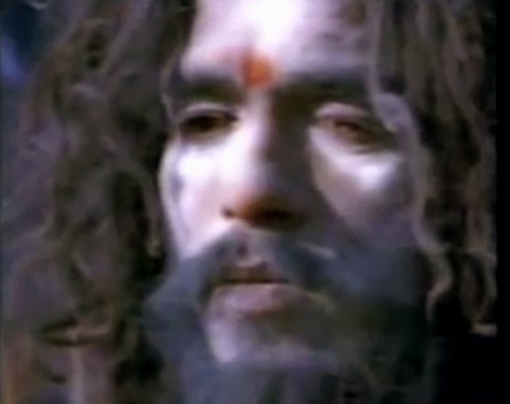 Baba with ash during a ritual with his guru. A still from Sadhus: India's Holy Men/Living With The Dead (1995), a film by Rajesh Bedi and Naresh Bedi. Colour, 50 mins.