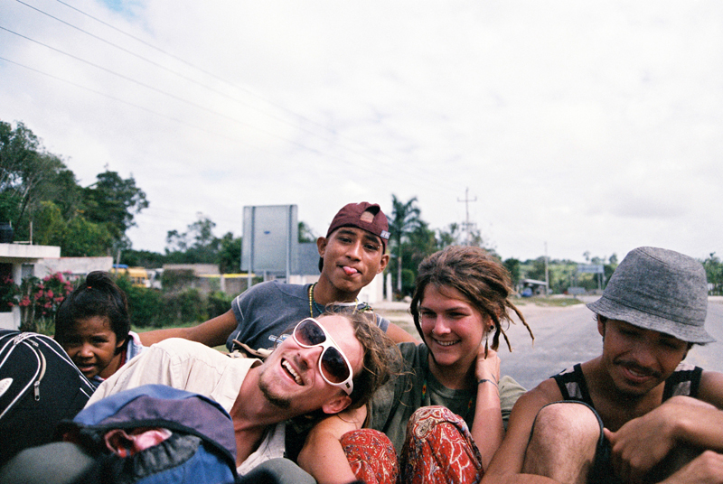 Hitchhiking on the back of a pick up truck.