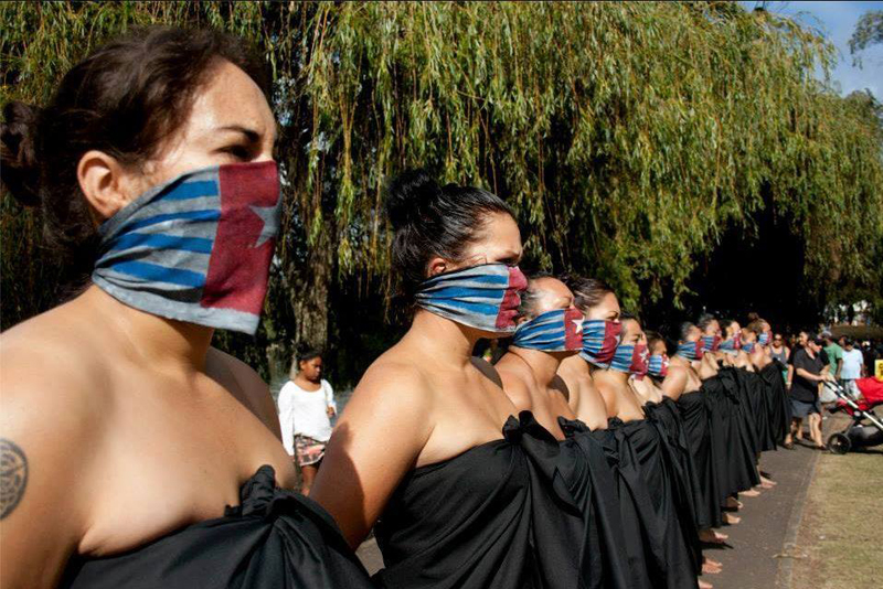 Indigenous Pacific women rise up for West Papua as part of the Oceania Interrupted movement, Australia, March 2014. "Our freedom as indigenous Māori and Pacific women in Aotearoa New Zealand is inextricably bound up with that of our Pacific West Papuan brothers and sisters. Our mouths are adorned with the Morning Star flag as symbol of enforced West Papuan silence.' - Oceania Interrupted Action 3 Free Pasifika - Free West Papua. Photo Sangeeta Singh.