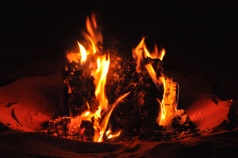 The Road Junky fire at night in the desert.