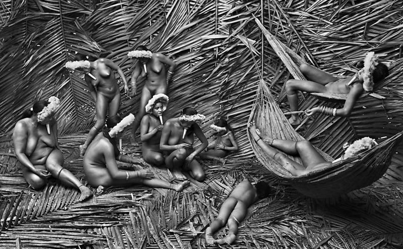 Typically, the women in the Zo’é village of Towari Ypy use the “urucum” (Bixa orellana) red fruit to color their bodies. It is also used in the cooking. The urucum is a shrub or small tree originating from tropical regions of the Americas. BRAZIL, 2009.