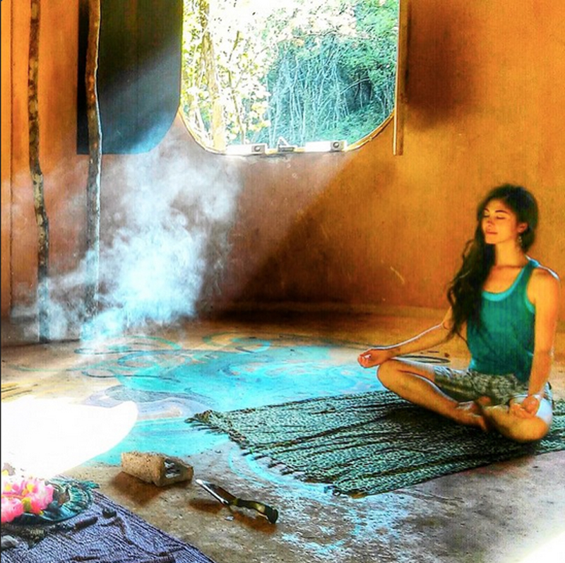 A Lemurian meditating inside the large palapa, a serene moment.