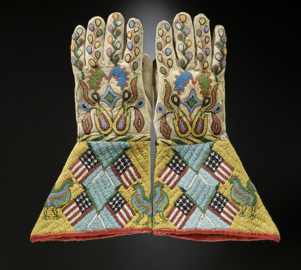 Gauntlets, c. 1890. Sioux-Métis artist, North or South Dakota. Native tanned leather, glass and brass beads, cotton cloth. 14 ó x 8 in. (36.8 x 20.3 cm) United States, Hirschfield Family Collection, Courtesy of Berte and Alan Hirschfield.