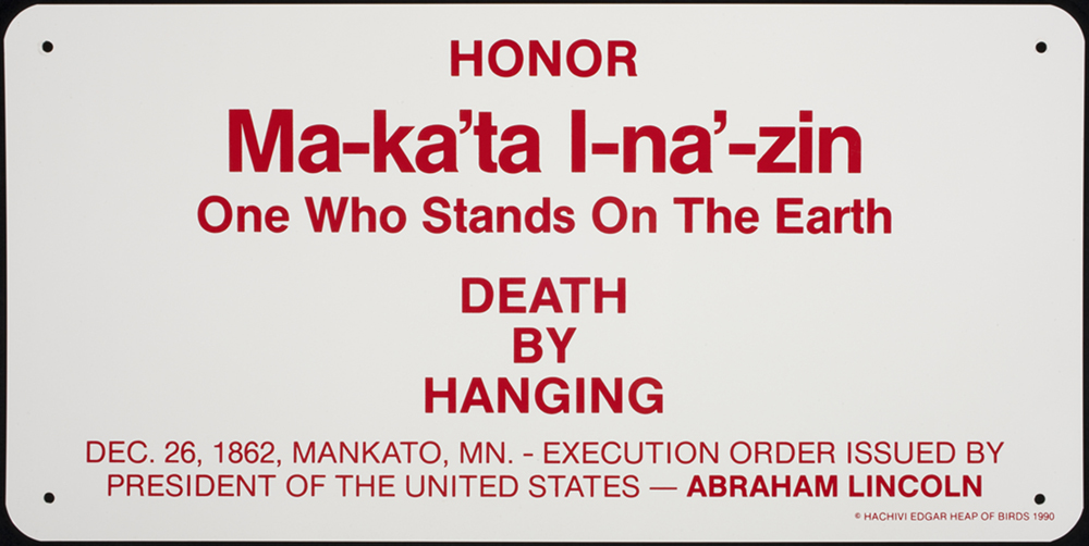 Ma-ka’tal-na’-zin (One Who Stands on the Earth), 38 signs from Building Minnesota (site specific public work), 1990 by Edgar Heap of Birds, Hock E Aye Vi. Enamel on aluminum 18 x 36.25 x .0625 in. Collection Walker Art Center, Minneapolis. Acquired in conjunction with the exhibition Claim Your Color: Hachivi Edgar Heap of Birds (1990), 1993.